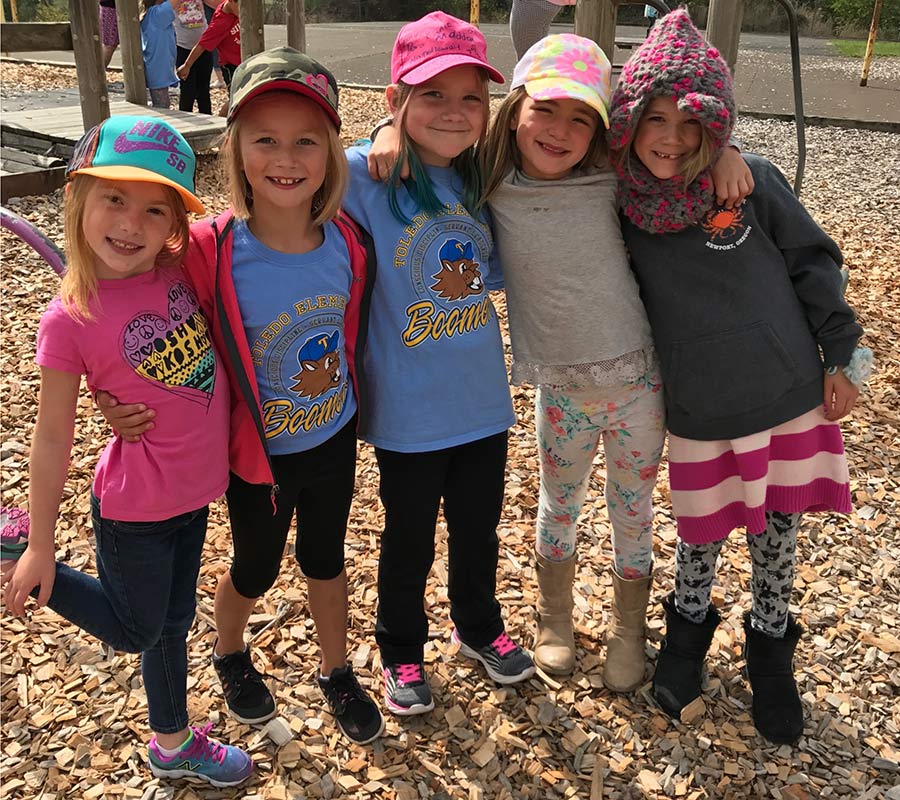 Girls on playground wearing hats