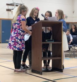 students speaking at assembly